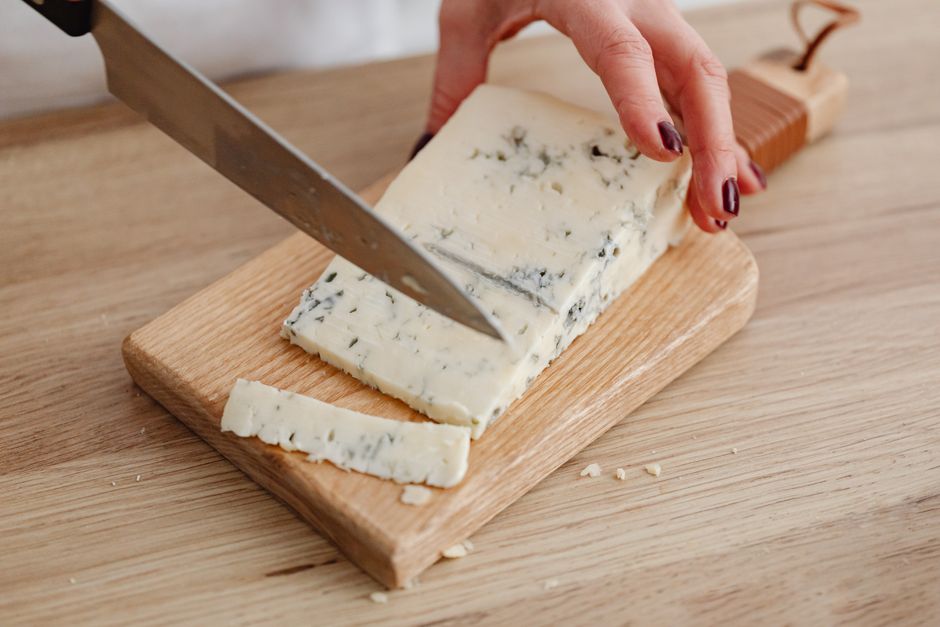 What Causes Cheese Holes: Bacteria Gas Explained